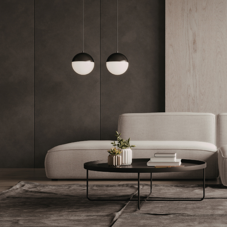 Black and white globe pendants above a cream sofa with a black coffee table.